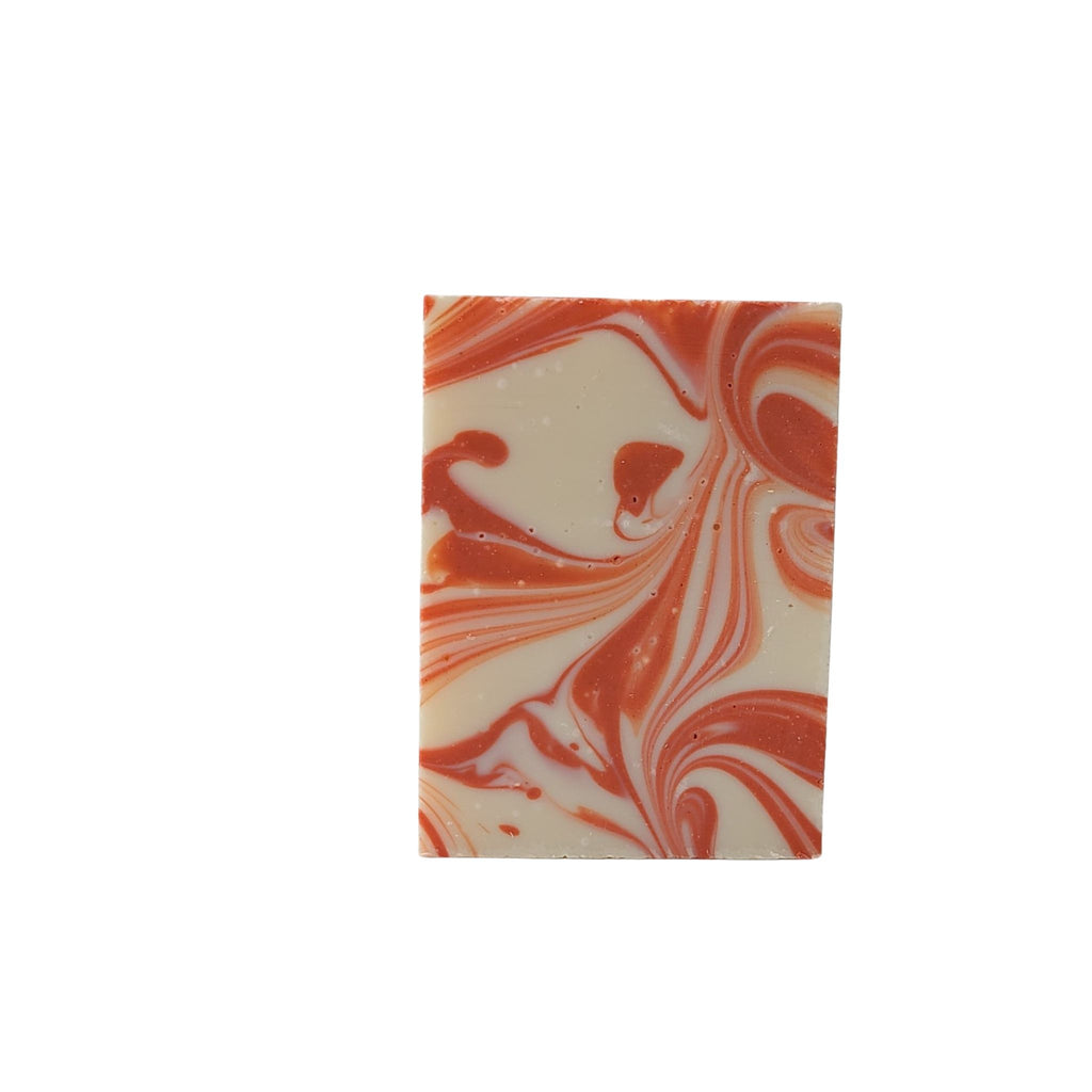 Ruby Tuesday soap with red swirls cheery grapefruit, warming ginger and grounding palmarosa. essential oils